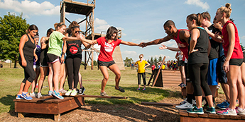 students working together on the low ropes course