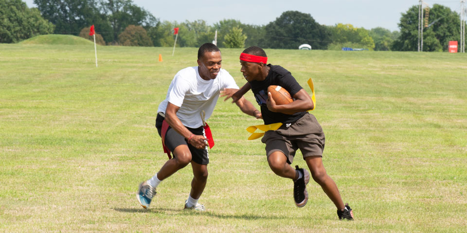 Two students play flag football.
